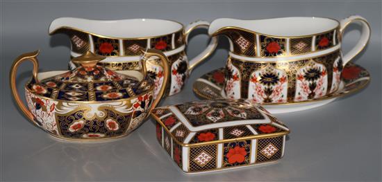 Royal Crown Derby: A pair of sauceboats, an oval plate, a sugar bowl and a casket